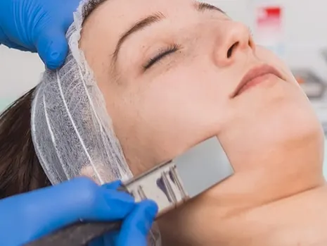 woman getting a chemical peel treatment on her face