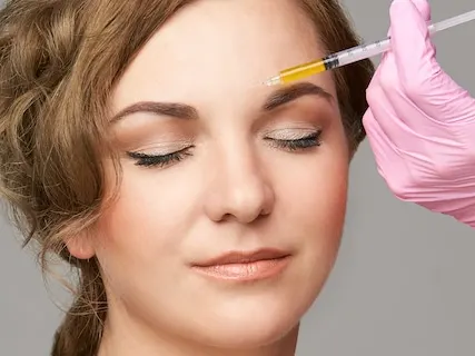Woman getting botox injections in the forehead
