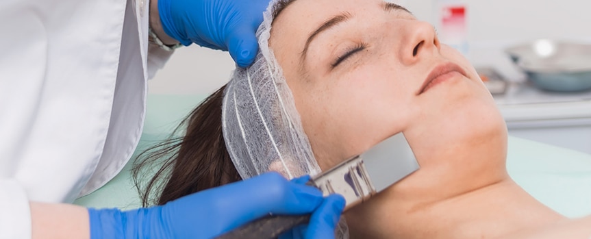 woman getting a chemical peel treatment on her face