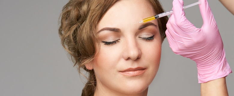 Woman getting botox injections in the forehead