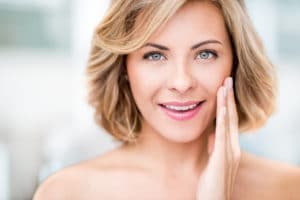 Beauty portrait of a woman stroking her skin