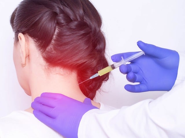 Doctor injects plasma therapy into the girl's neck to relieve pain